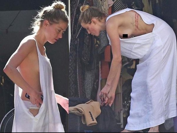 Amber Heard suffers an unfortunate wardrobe malfunction as she’s cleaning out her garage