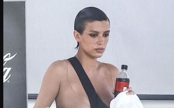 Kanye West's 'wife' Bianca Censori to be punished by Italian police for public indecency as she steps out in outrageous transparent catsuit and is forced to cover her ni**les with a bag